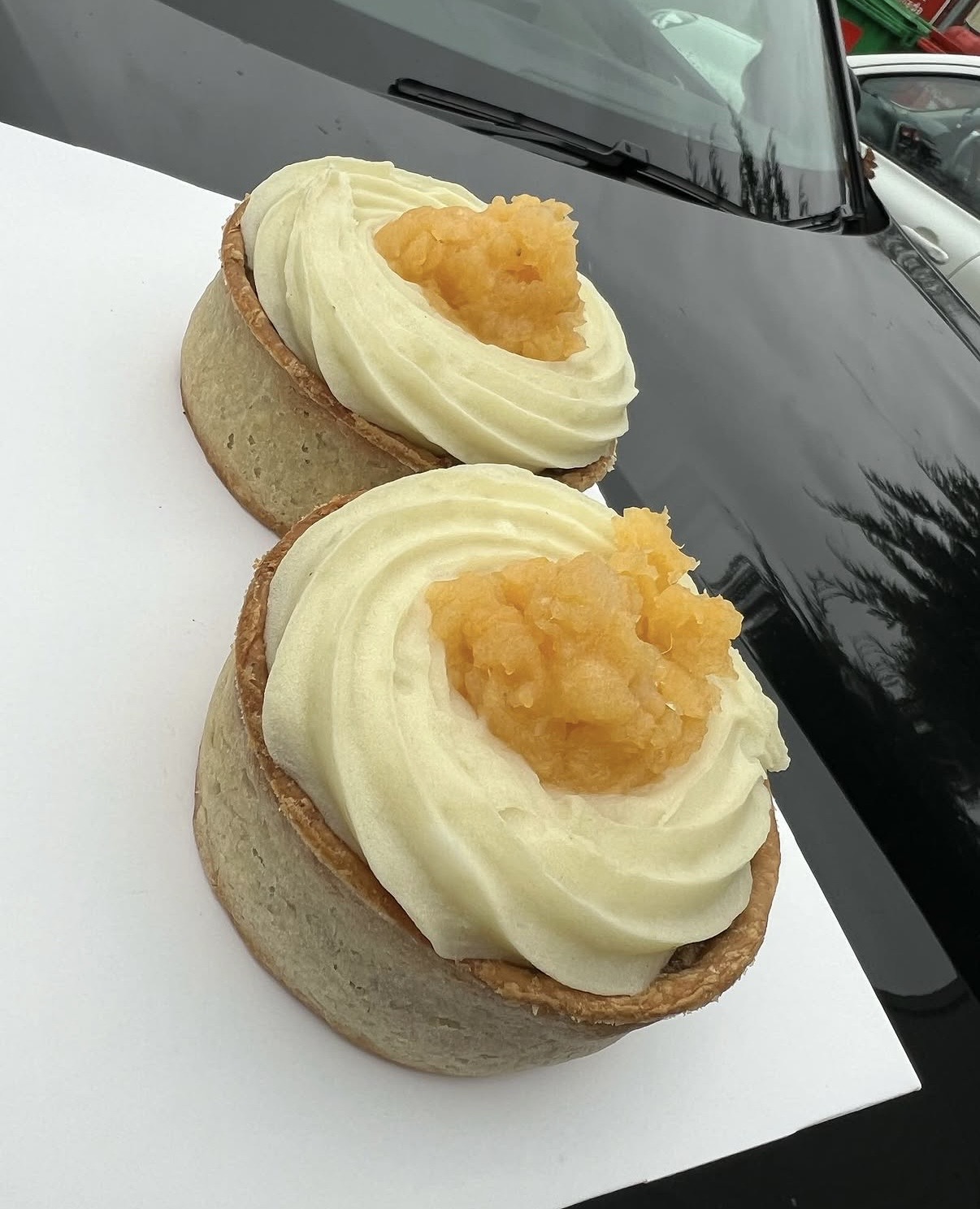 Two savoury pies with piped potato and orange vegetable topping